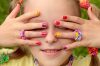 Children's multi-colored manicure with stripes on the girl in the summer.